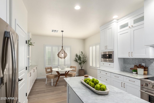 896 E Indian Wells Pl, Chandler, AZ 85249 - kitchen with appliances with stainless steel finishes, light wood finished floors, light stone countertops, white cabinets, and recessed lighting