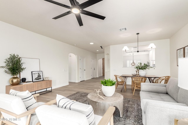 896 E Indian Wells Pl, Chandler, AZ 85249 - living area with arched walkways, light wood-style flooring, a ceiling fan, recessed lighting, and baseboards