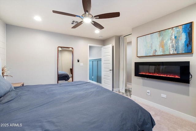5707 N 12th Pl, Phoenix, AZ 85014 - carpeted bedroom with a glass covered fireplace, baseboards, recessed lighting, and a ceiling fan
