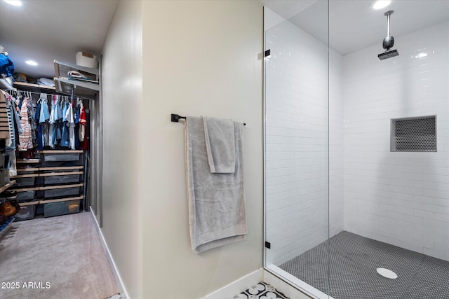 5707 N 12th Pl, Phoenix, AZ 85014 - bathroom with a stall shower, baseboards, a spacious closet, and recessed lighting
