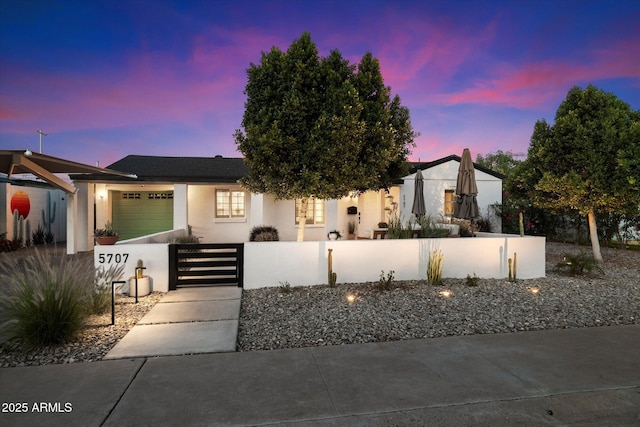 5707 N 12th Pl, Phoenix, AZ 85014 - view of front of property featuring a fenced front yard, stucco siding, and an attached garage