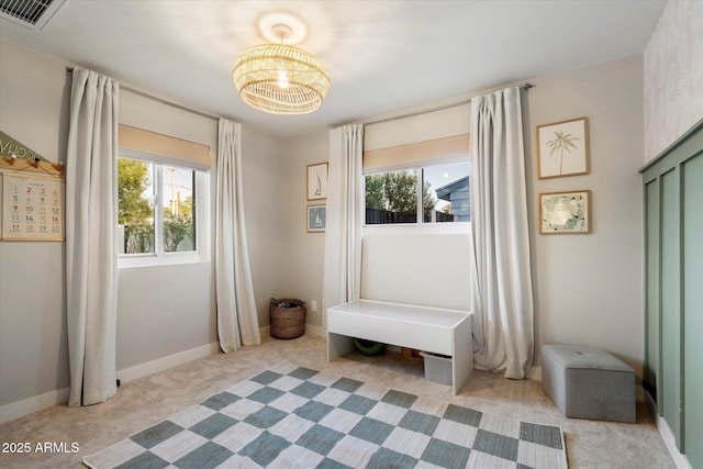 5707 N 12th Pl, Phoenix, AZ 85014 - unfurnished room with plenty of natural light, light colored carpet, a chandelier, and baseboards