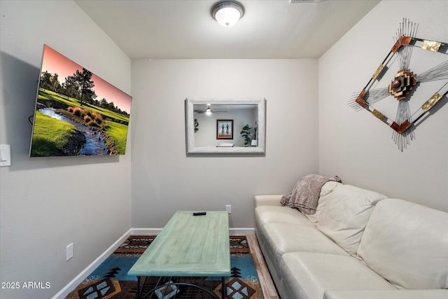 5707 N 12th Pl, Phoenix, AZ 85014 - living room featuring baseboards and a ceiling fan