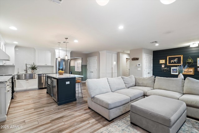 5707 N 12th Pl, Phoenix, AZ 85014 - living area featuring light wood finished floors, recessed lighting, and wine cooler