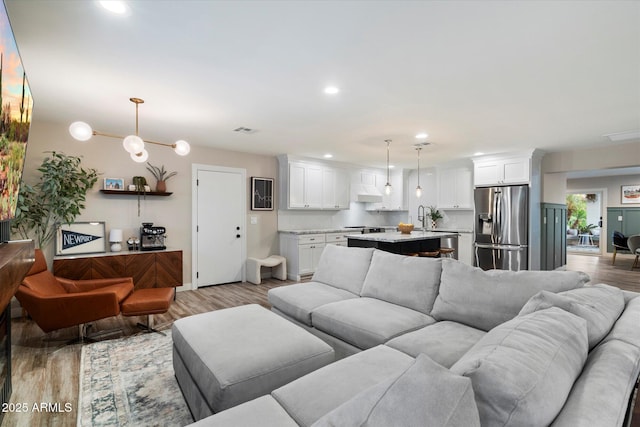5707 N 12th Pl, Phoenix, AZ 85014 - living room featuring light wood-type flooring and recessed lighting