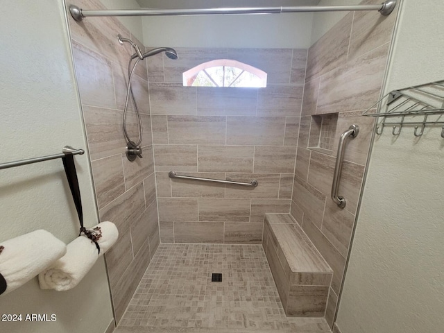 bathroom with a tile shower