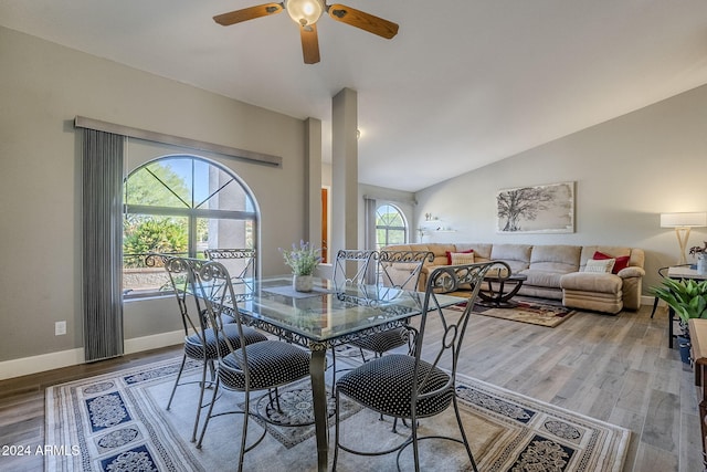 dining area with ceiling fan, wood-type flooring, and lofted ceiling