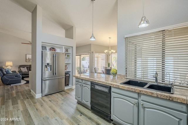 kitchen featuring dishwasher, sink, high end refrigerator, vaulted ceiling, and light wood-type flooring