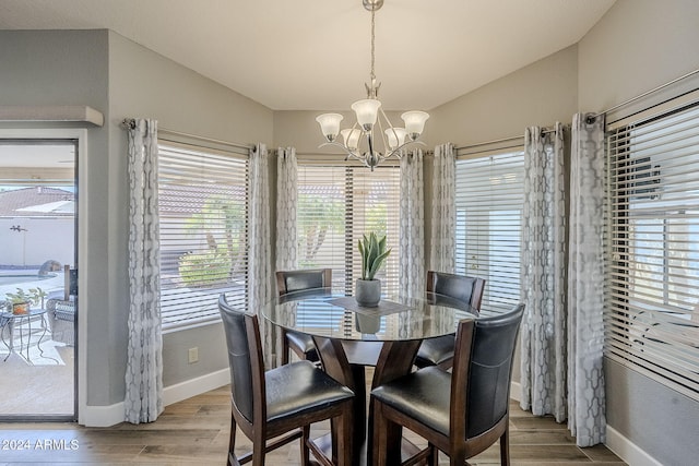 dining area featuring light hardwood / wood-style flooring and an inviting chandelier