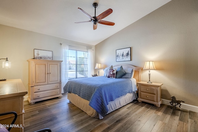 bedroom with ceiling fan, dark hardwood / wood-style flooring, and lofted ceiling