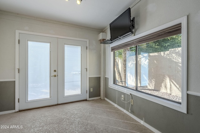 entryway with light carpet and french doors