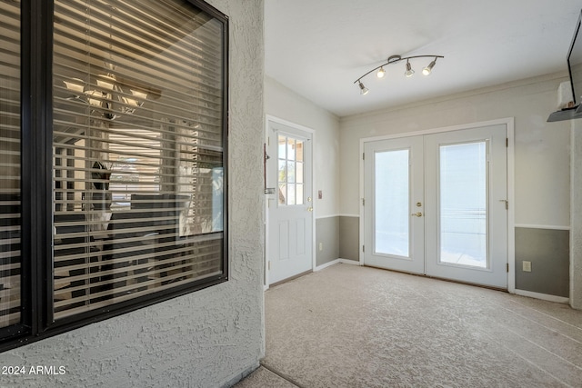 doorway to outside with carpet and french doors