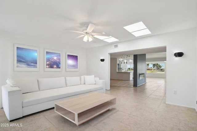 living room with ceiling fan and light tile patterned flooring