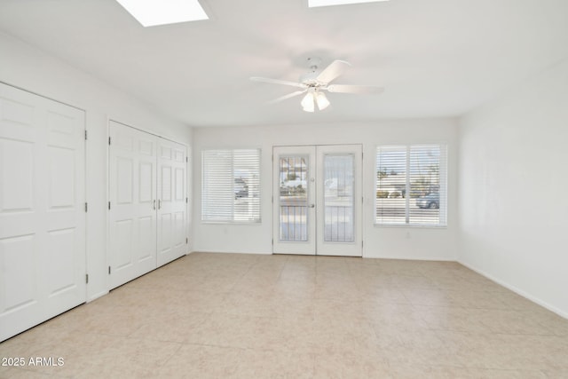 interior space featuring french doors, two closets, and ceiling fan