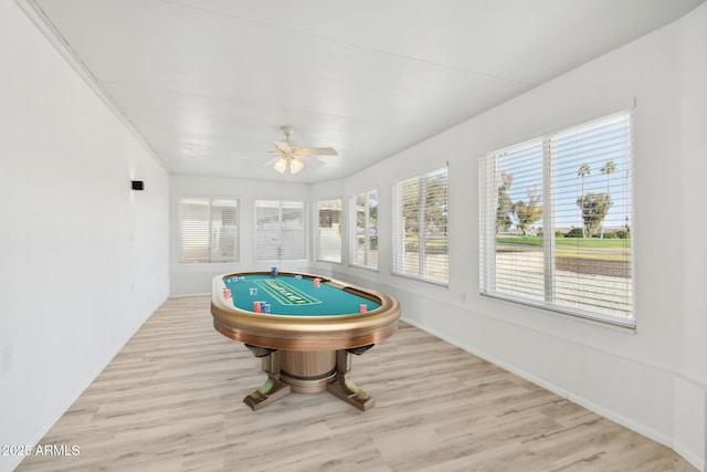 game room with ceiling fan, light hardwood / wood-style floors, and ornamental molding