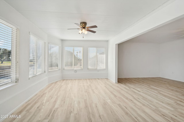 unfurnished sunroom featuring a wealth of natural light and ceiling fan