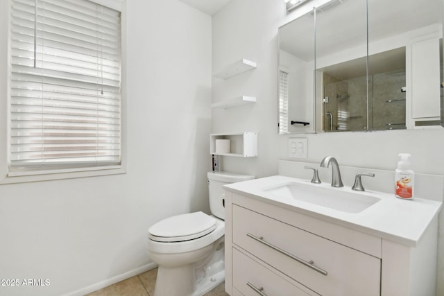 bathroom featuring tile patterned flooring, vanity, a shower with door, and toilet