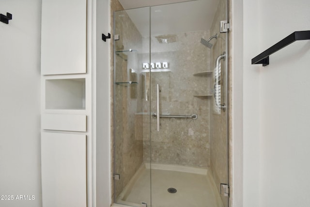 bathroom featuring a shower with shower door