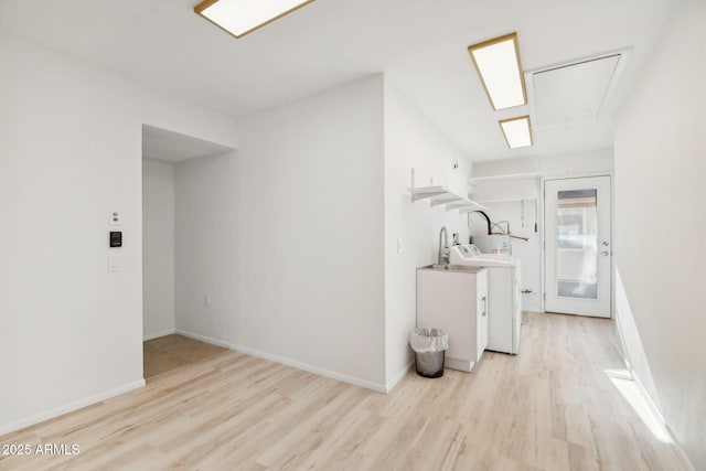 interior space featuring light wood-type flooring and washer / clothes dryer