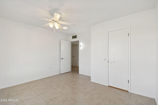 unfurnished bedroom with ceiling fan and a closet