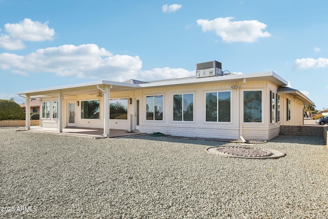 back of property with a patio and central AC