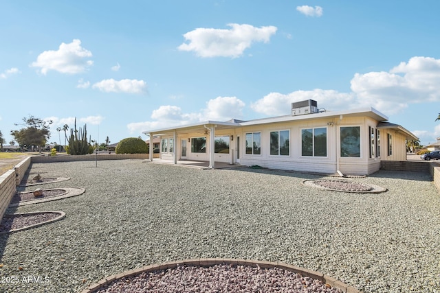 rear view of property with a patio and central AC unit