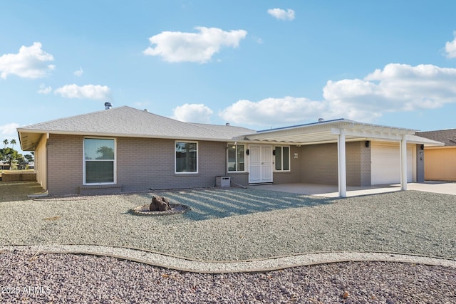 rear view of property featuring a garage