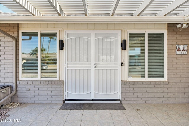 entrance to property with a pergola