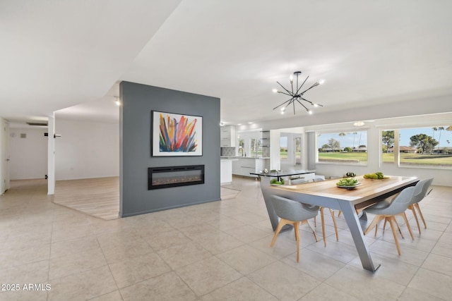 tiled dining space featuring an inviting chandelier