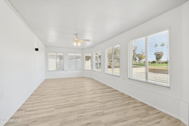 unfurnished sunroom featuring ceiling fan