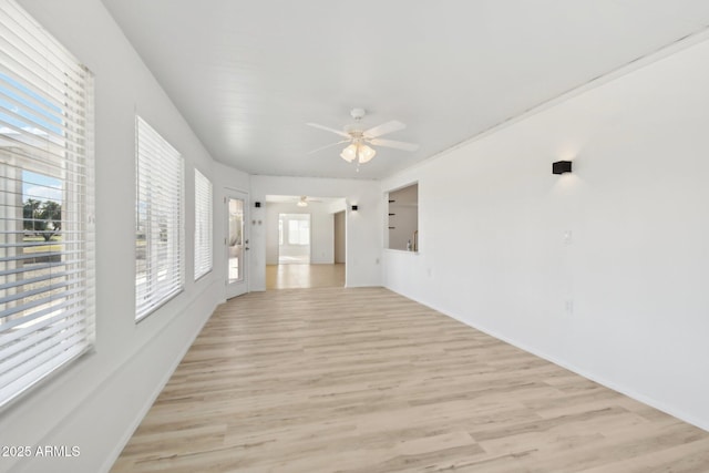 spare room with ceiling fan and light wood-type flooring