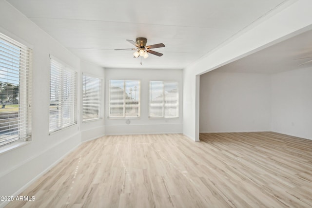 unfurnished sunroom with a wealth of natural light and ceiling fan