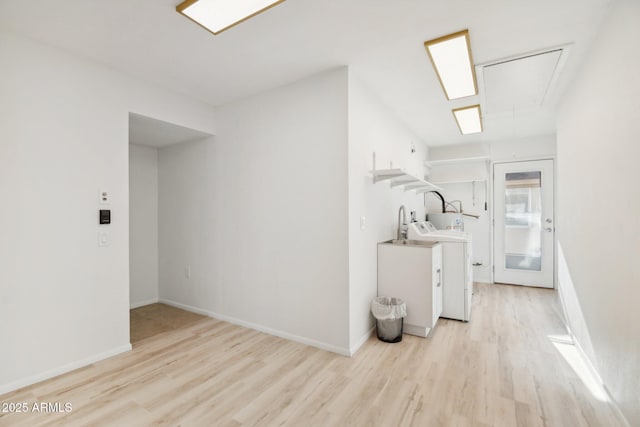 interior space featuring washer / clothes dryer and light hardwood / wood-style floors