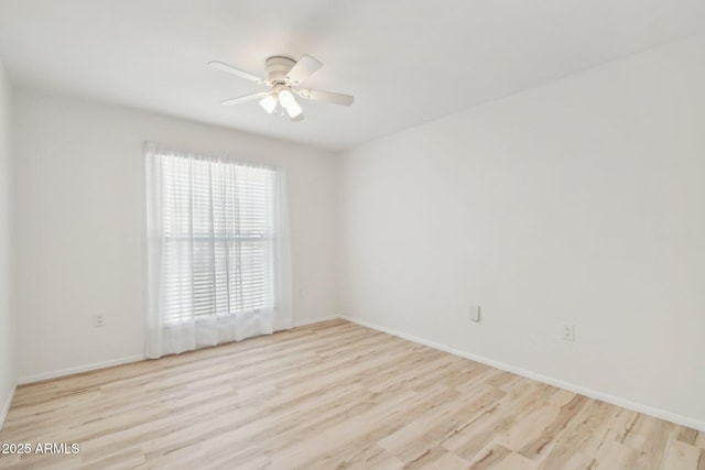 empty room featuring light wood-type flooring and ceiling fan