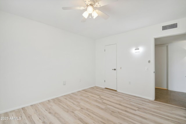 spare room featuring light wood-type flooring and ceiling fan