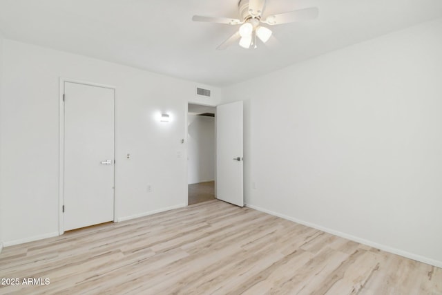 empty room with light hardwood / wood-style floors and ceiling fan