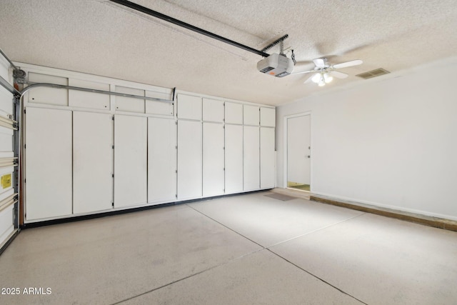 garage with ceiling fan and a garage door opener