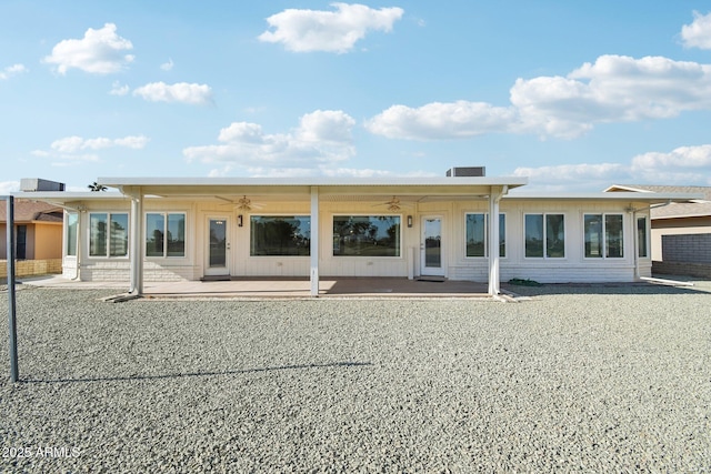 back of property with ceiling fan and a patio area