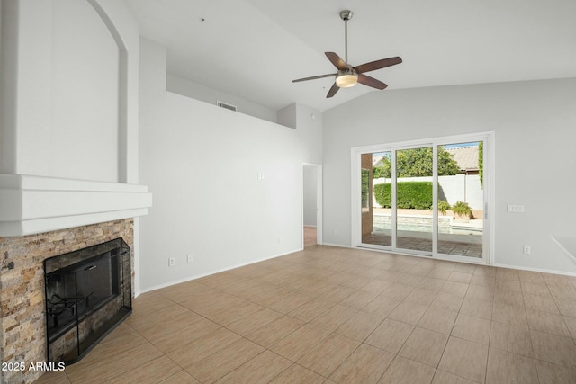 unfurnished living room featuring visible vents, lofted ceiling, a stone fireplace, baseboards, and ceiling fan