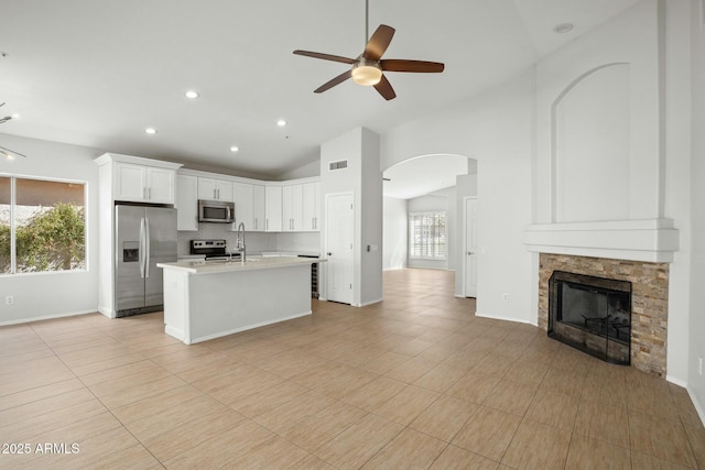 kitchen with visible vents, open floor plan, stainless steel appliances, light countertops, and a healthy amount of sunlight