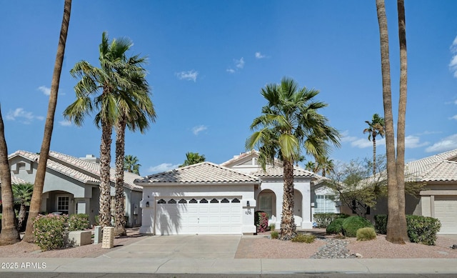 view of front of house with stucco siding, a garage, concrete driveway, and a tiled roof