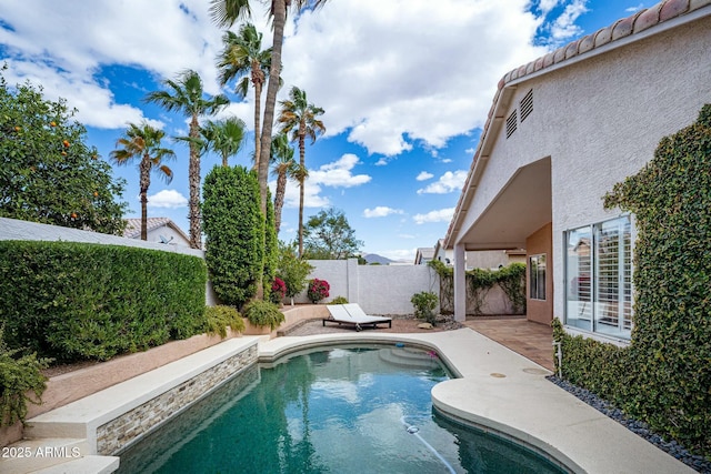 view of swimming pool featuring a fenced in pool, a patio, and a fenced backyard