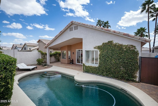 view of swimming pool featuring fence and a patio area