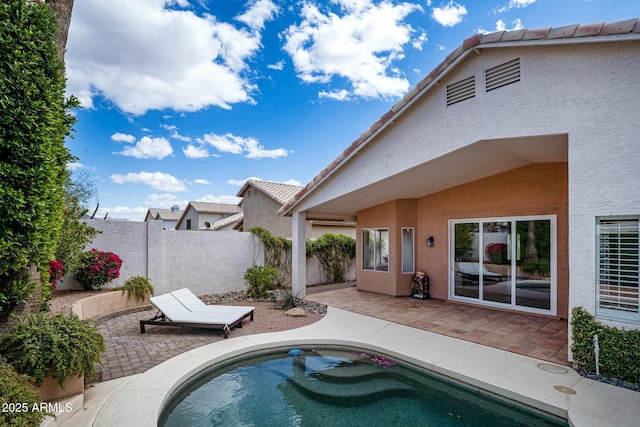 view of pool with a fenced backyard and a patio