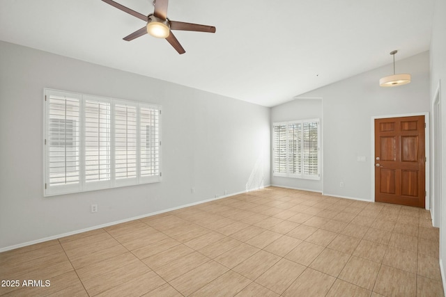 empty room with baseboards, ceiling fan, and vaulted ceiling