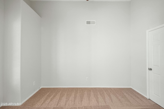 empty room featuring visible vents, baseboards, and carpet floors