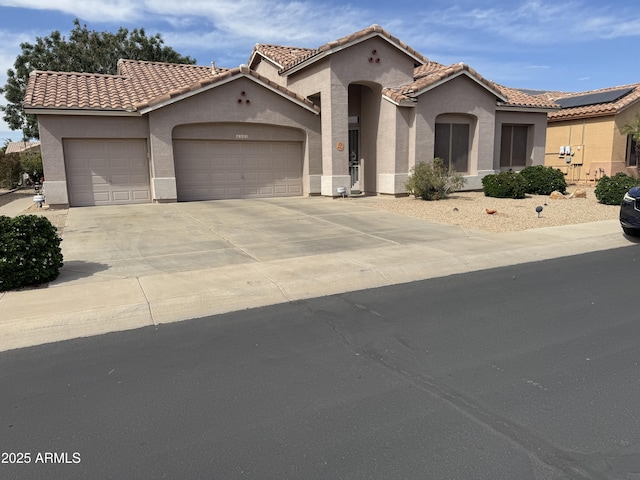 4540 E Mia Ln, Gilbert, AZ 85298 - mediterranean / spanish-style house featuring a garage, a tile roof, concrete driveway, and stucco siding