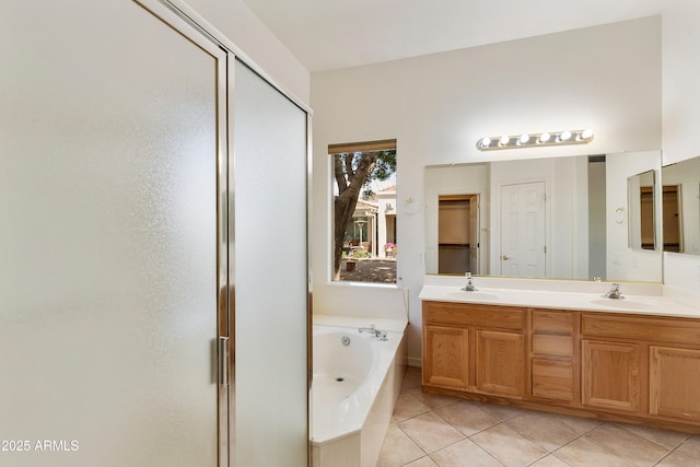 4540 E Mia Ln, Gilbert, AZ 85298 - bathroom with tile patterned floors, double vanity, a sink, a garden tub, and a stall shower