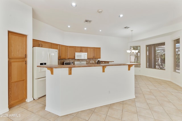 4540 E Mia Ln, Gilbert, AZ 85298 - kitchen featuring visible vents, white appliances, a kitchen bar, and light tile patterned flooring