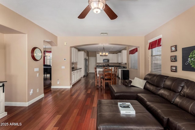 3065 E Harvard Ave, Gilbert, AZ 85234 - living room with arched walkways, ceiling fan, healthy amount of natural light, and dark wood-type flooring